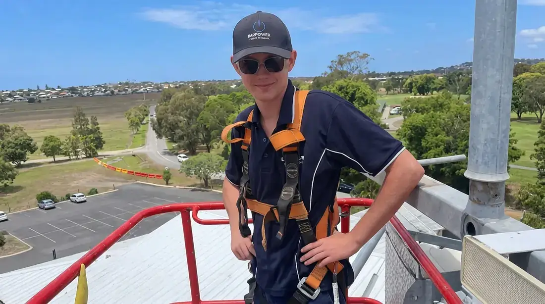 Infuse Electrical team member wearing a safety harness while working at heights in Mackay